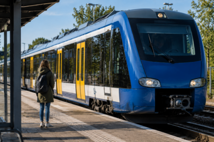 KI-generiertes Symbolbild: Symbolbild: Szene eines blau-gelben Regionalzuges an einem Bahnsteig